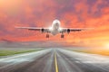 Flying and traveling, sunset airplane landing runway airport. Royalty Free Stock Photo
