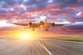 Flying and traveling, sunset airplane landing runway airport. Royalty Free Stock Photo