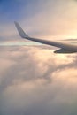 Flying and traveling. View of airplane wing during sunset. Plane over clouds in the sky. Royalty Free Stock Photo