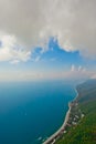 Flying under the clouds along the turquoise sea and the green coast with many hotels. aerial photo from a paraglider, summer Royalty Free Stock Photo
