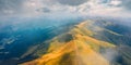 Panoramic summer view from flying drone of Krasna range with old country road. Misty morning view of Carpathian mountains, Ukraine Royalty Free Stock Photo