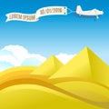 Flying vintage plane with banner and pyramids, desert landscape.