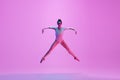 Young and graceful ballet dancer isolated on pink studio background in neon light. Art, motion, action, flexibility Royalty Free Stock Photo