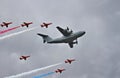 Flypast of RAF Red Arrows escorting an Airbus A400M Royalty Free Stock Photo