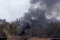 Flytipping fire. Enironmental pollution from black smoke in the countryside