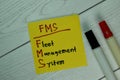 FMS - Fleet Management System write on sticky notes isolated on Wooden Table Royalty Free Stock Photo