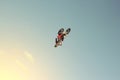 FMX biker doing a back flip on a background of blue sky