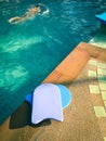 Foam board for the teaching of swimming beside swimming pool, Asian Boy Practice Swimming Royalty Free Stock Photo