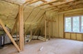 Foam plastic insulation installed in the sloping attic of new frame house