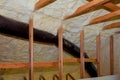 Foam plastic insulation installed in the sloping ceiling of new frame house