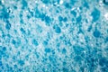 Foam on surface of liquid blue detergent household chemicals, big and small bubbles, close-up full depth of field, top view Royalty Free Stock Photo