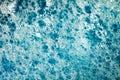 Foam on surface of liquid blue detergent household chemicals, big and small foamed bubbles, close-up full depth of field, top view Royalty Free Stock Photo