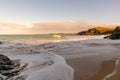 A sandy Cornish beach bathed in a golden glow as the sun begins to set Royalty Free Stock Photo