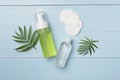 Foaming facial cleanser and micellar water on wooden background, top view Royalty Free Stock Photo