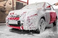 Foaming red auto at car wash