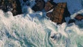 Foaming sea crashing cliff slow motion. Aerial view foamy water splashing shore Royalty Free Stock Photo