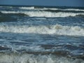 Foaming sea wave layers close up on the ocean