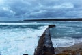 Waves hit the the harbour wall at Sennen Cove Cornwall UK Royalty Free Stock Photo