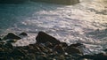 Foaming shallow sea water washing rocky coast closeup. Beautiful ocean waving Royalty Free Stock Photo