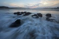 Foaming waters at sunset on a beach