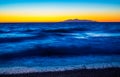 Foamy Aegean Sea Black beach sunrise view Kamari village Santorini Greece Royalty Free Stock Photo