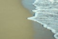 Foamy beach sea wave over sand Royalty Free Stock Photo