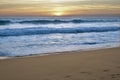 Foamy beach waves with amazing sunset. Endless horizon. Stunning colors Royalty Free Stock Photo