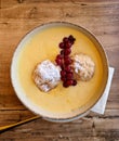 Foamy cottage cheese dumplings with vanilla extract and currants