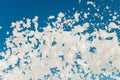 White airy foam on a blue sky background blowing from lather maker gun