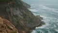 Foamy ocean cliff landscape aerial view. Deep blue sea around rocky shore island Royalty Free Stock Photo