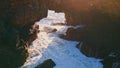 Foamy ocean water bubbling at coastal cliffs. Aerial stormy sea waves breaking Royalty Free Stock Photo