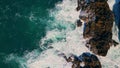 Foamy ocean water splashing on coastal crag aerial view. Waves crashing rocks. Royalty Free Stock Photo