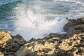 Foamy sea splashes on a rocky shore. Fresh breeze. Close-up Royalty Free Stock Photo