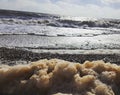 Foamy sea. Suffolk Coast. Royalty Free Stock Photo