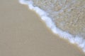 Foamy sea wave on sand beach photo background. Tide on white beach sande. Tropical seashore idyllic view Royalty Free Stock Photo