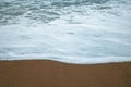 FOAMY SEAWATER PUSHING OUT OVER THE BEACH Royalty Free Stock Photo