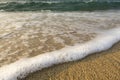 Foamy soft wave on sand beach Royalty Free Stock Photo