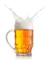 Foamy splash of light beer in faceted mug Royalty Free Stock Photo