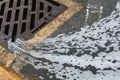 Foamy water leaks to the street sewage drainage grid