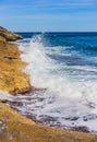 Foamy water ocean waves, hitting against rocky coast, rough seascape Royalty Free Stock Photo