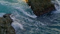 Foamy water rolling on abandoned rocks closeup. Swirling aqua at morning nature