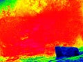 Foamy water of waterfall, looks like hot magma. Cold water of mountain river in infrared photo. Amazing thermography.