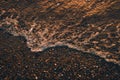 Foamy wave crashing the shore at sunset, cool for background