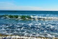 Foamy waves in blue sea with beach Royalty Free Stock Photo