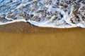 Foamy waves in blue sea with beach Royalty Free Stock Photo