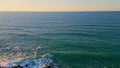 Foamy waves rolling rocky coastline aerial picturesque ocean view in slow motion