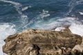 Foamy waves of the surf near the rocky shore