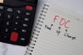 FOC - Free Of Charge write on a book isolated wooden table