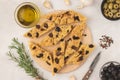 Focaccia bread with olives, garlic, oregano and olive oil, top view, flat lay. Royalty Free Stock Photo