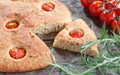 Focaccia with cherry tomatoes, fresh rosemary, peperone, selective focus Royalty Free Stock Photo